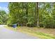 A wooded lot with a real estate sign ready for your custom build at 307 Stillwater Rd, Troutman, NC 28166