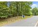A wooded lot with a real estate sign ready for your custom build at 307 Stillwater Rd, Troutman, NC 28166