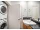 Functional bathroom features a side by side washer dryer and granite countertops at 333 W Trade St # 1802, Charlotte, NC 28202