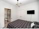 Modern bedroom with tv features stylish lighting and a doorway to the bathroom at 333 W Trade St # 1802, Charlotte, NC 28202