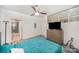 A bedroom has a ceiling fan, a dresser, and access to a bathroom, with a window letting in soft light at 333 W Trade St # 1802, Charlotte, NC 28202