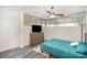 A bedroom features a ceiling fan, a dresser with a tv, and a window that allows for soft, natural light at 333 W Trade St # 1802, Charlotte, NC 28202