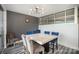 A dining room boasts a modern light fixture, beautiful grey walls, and a marble table with grey and blue seating at 333 W Trade St # 1802, Charlotte, NC 28202