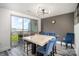 Modern dining room with a marble table, blue chairs, and an open layout with access to the balcony at 333 W Trade St # 1802, Charlotte, NC 28202