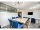 A modern dining room boasts a marble table, blue chairs, and an open layout with access to the kitchen at 333 W Trade St # 1802, Charlotte, NC 28202