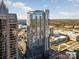 Modern high-rise with reflective glass facade, pool deck, and city views under a bright sky at 333 W Trade St # 1802, Charlotte, NC 28202