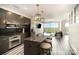 Modern kitchen with stainless steel appliances, a dark backsplash, and an open layout with a granite island at 333 W Trade St # 1802, Charlotte, NC 28202