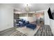 Open-concept layout with stylish furnishings, modern lighting, and sleek hardwood floors at 333 W Trade St # 1802, Charlotte, NC 28202