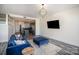 Well-lit living room with modern decor, open to the kitchen, and a large-screen TV at 333 W Trade St # 1802, Charlotte, NC 28202