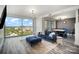 Modern living room with a blue velvet sofa, city views, and contemporary lighting fixtures at 333 W Trade St # 1802, Charlotte, NC 28202