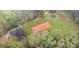 Aerial view of a brick home and cleared land and wooded perimeter on the property at 3720 Lanes Creek Rd, Marshville, NC 28103