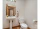 A pedestal sink and toilet create an elegant powder room at 3720 Lanes Creek Rd, Marshville, NC 28103
