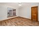 Bright bedroom with light wood floors, a ceiling fan, and a window overlooking the yard at 3720 Lanes Creek Rd, Marshville, NC 28103