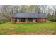 Front exterior of a brick home with a cozy covered porch and well-maintained green lawn at 3720 Lanes Creek Rd, Marshville, NC 28103