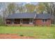 Inviting single-story brick home featuring a covered front porch and manicured lawn at 3720 Lanes Creek Rd, Marshville, NC 28103
