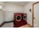 Laundry room with side-by-side machines and a wire shelf at 3720 Lanes Creek Rd, Marshville, NC 28103