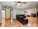 Open living room with hardwood floors, a fireplace, and neutral walls providing a versatile space for living at 3720 Lanes Creek Rd, Marshville, NC 28103
