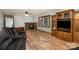 Inviting living room with hardwood floors, brick fireplace, bay window, and stylish furniture at 3720 Lanes Creek Rd, Marshville, NC 28103