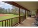 Spacious covered porch with wood beams, offering scenic views of the expansive yard and surrounding nature at 3720 Lanes Creek Rd, Marshville, NC 28103