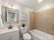 Cozy bathroom with tiled shower/tub combination, white vanity, and a decorative mirror at 3911 Kitley Pl, Charlotte, NC 28210