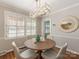 Bright dining room with modern lighting, plantation shutters, and elegant decor for a welcoming atmosphere at 3911 Kitley Pl, Charlotte, NC 28210