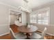 Sunlit dining room features unique light fixture and access to a living area with built-in shelving at 3911 Kitley Pl, Charlotte, NC 28210