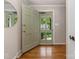Entryway featuring hardwood floors and a lovely sage-green front door at 3911 Kitley Pl, Charlotte, NC 28210