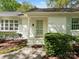 Welcoming front porch with painted brick, pastel door and mature landscaping at 3911 Kitley Pl, Charlotte, NC 28210