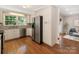 Spacious kitchen with stainless steel appliances, white cabinets, granite countertops, and hardwood floors at 3911 Kitley Pl, Charlotte, NC 28210