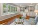 Bright living room with hardwood floors, built-in shelving, and a large bay window at 3911 Kitley Pl, Charlotte, NC 28210