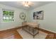 Bright home office featuring hardwood floors, a ceiling fan, modern art, and a view to the outdoors at 3911 Kitley Pl, Charlotte, NC 28210