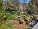 Aerial view showcasing a sprawling backyard with lush lawn, mature trees, and inviting deck area at 4098 Kiser Cove Ln, Terrell, NC 28682