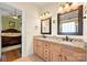 Bathroom features a double sink vanity with granite counters and tile floors at 4098 Kiser Cove Ln, Terrell, NC 28682