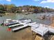 Lakefront dock with multiple boat slips, offering easy access to water activities and scenic views at 4098 Kiser Cove Ln, Terrell, NC 28682
