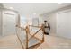 Upstairs hallway with hardwood railing, neutral paint, and views to living area at 4098 Kiser Cove Ln, Terrell, NC 28682