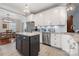 Renovated kitchen with stainless steel appliances, a dark island, and white cabinets at 4098 Kiser Cove Ln, Terrell, NC 28682