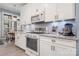 Updated kitchen features white cabinets, granite countertops, and stainless steel appliances at 4098 Kiser Cove Ln, Terrell, NC 28682