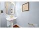 Charming powder room with pedestal sink, gold accents, and classic details at 4098 Kiser Cove Ln, Terrell, NC 28682