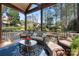 Screened in porch with wicker sofas, chairs, and a glass table at 4098 Kiser Cove Ln, Terrell, NC 28682