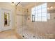 Spa-like bathroom featuring a glass enclosed shower, tiled bench, and neutral finishes at 4098 Kiser Cove Ln, Terrell, NC 28682