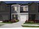 Charming townhome with gray siding, white trim, and a well-manicured front yard at 4333 Summit Woods Dr, Charlotte, NC 28216