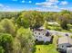 This aerial view showcases a charming home with a lush green lawn and mature trees, nestled in a serene neighborhood at 4375 Creek Ave, Midland, NC 28107