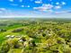 The aerial view showcases a picturesque town surrounded by lush green trees and a clear blue sky at 4375 Creek Ave, Midland, NC 28107