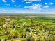 The aerial view showcases a picturesque town surrounded by lush green trees and a clear blue sky at 4375 Creek Ave, Midland, NC 28107