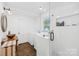 Modern bathroom featuring stylish vanity, walk-in shower, and washer/dryer at 4375 Creek Ave, Midland, NC 28107