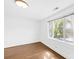 Bright bedroom features hardwood floors and a large window overlooking the lush landscape at 4375 Creek Ave, Midland, NC 28107