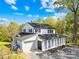 Beautiful two story home with white siding, black shutters, and black roof with mature landscaping at 4375 Creek Ave, Midland, NC 28107