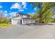 Beautiful two story home with white siding, black shutters, and black roof with mature landscaping at 4375 Creek Ave, Midland, NC 28107