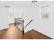 Hallway featuring wood floors, staircase, and bright natural light at 4375 Creek Ave, Midland, NC 28107