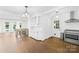 Open-concept kitchen featuring white cabinets, stainless steel appliances, hardwood floors, and bar seating at 4375 Creek Ave, Midland, NC 28107